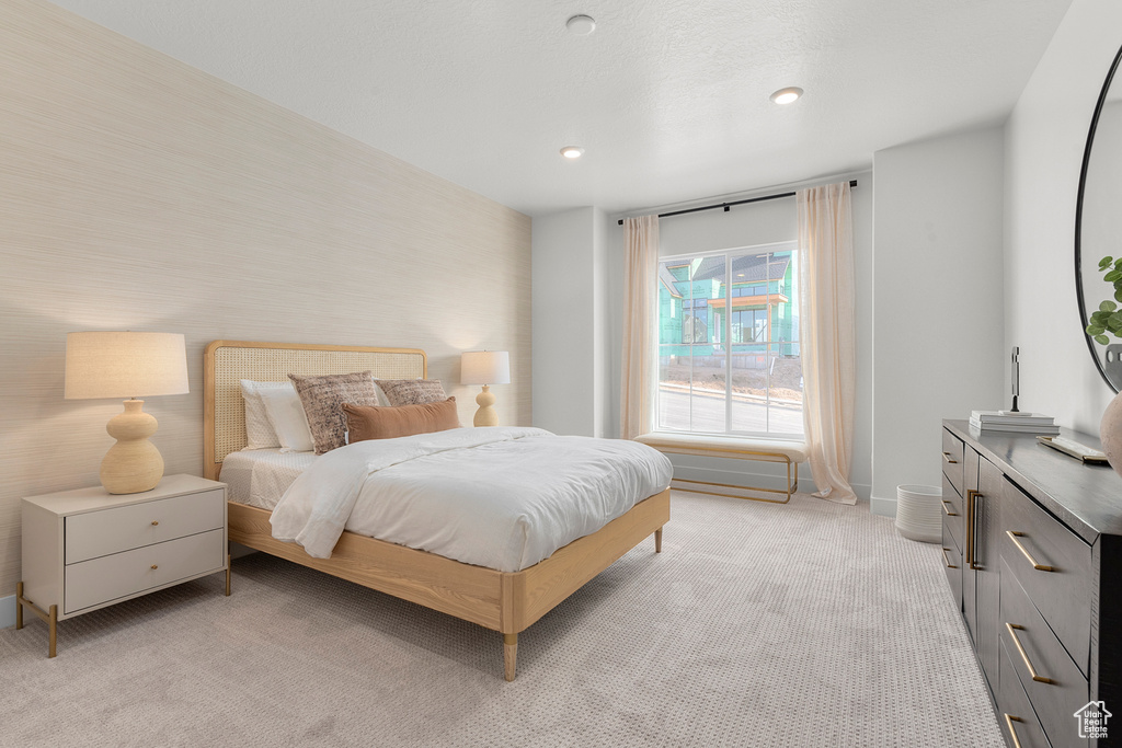 Bedroom with light carpet, baseboards, and recessed lighting