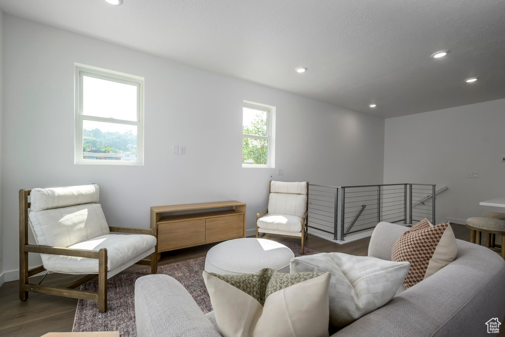 Sitting room with wood finished floors, baseboards, and recessed lighting