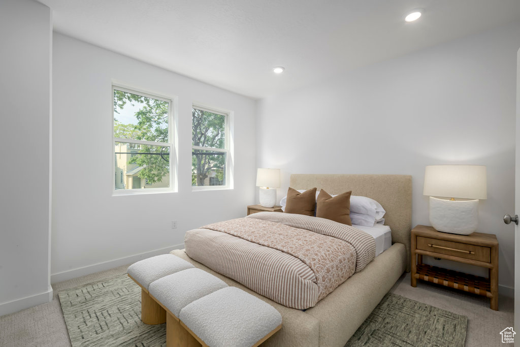 Bedroom with light colored carpet, baseboards, and recessed lighting
