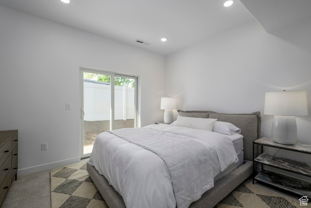 Bedroom with recessed lighting, access to exterior, and baseboards
