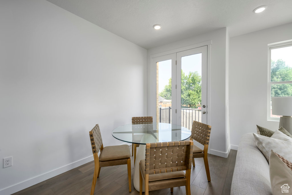 Dining room with baseboards, wood finished floors, and recessed lighting