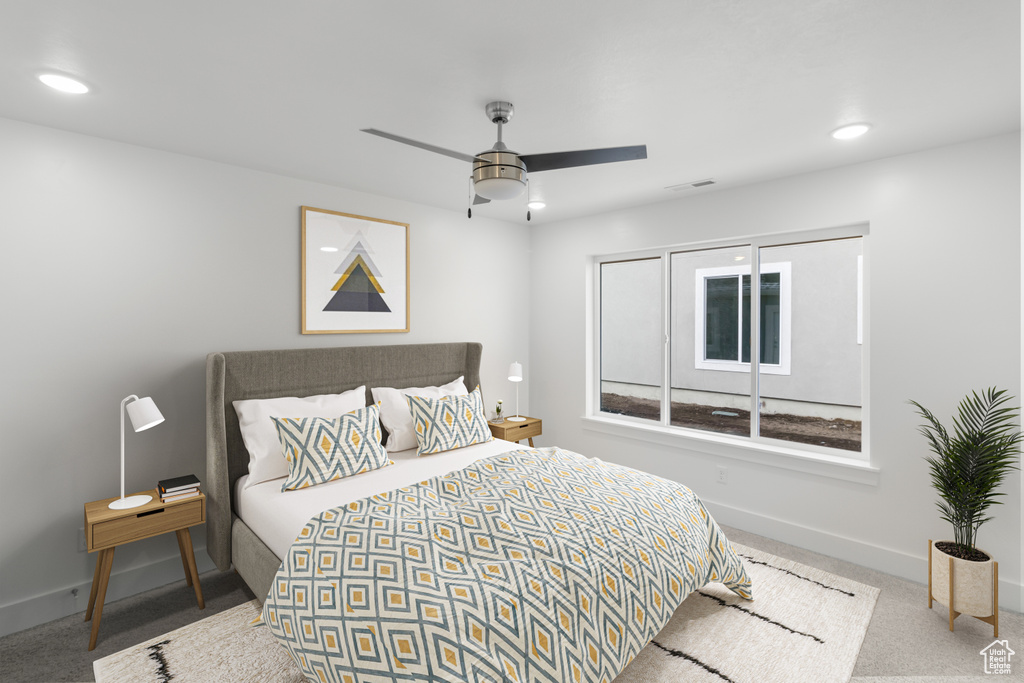 Carpeted bedroom featuring baseboards, recessed lighting, and ceiling fan