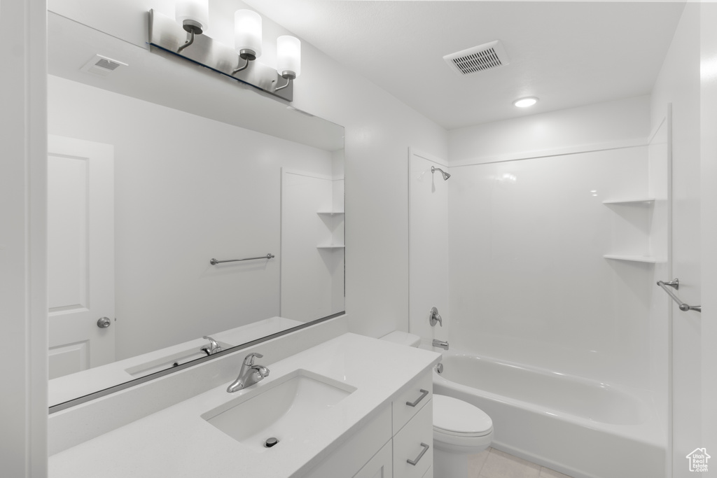Bathroom with toilet, vanity, shower / washtub combination, and tile patterned floors