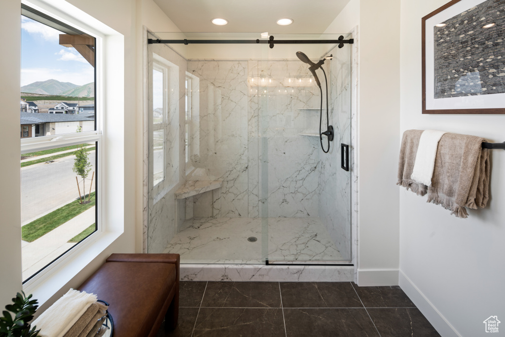 Full bathroom featuring plenty of natural light, a mountain view, a marble finish shower, baseboards, and recessed lighting