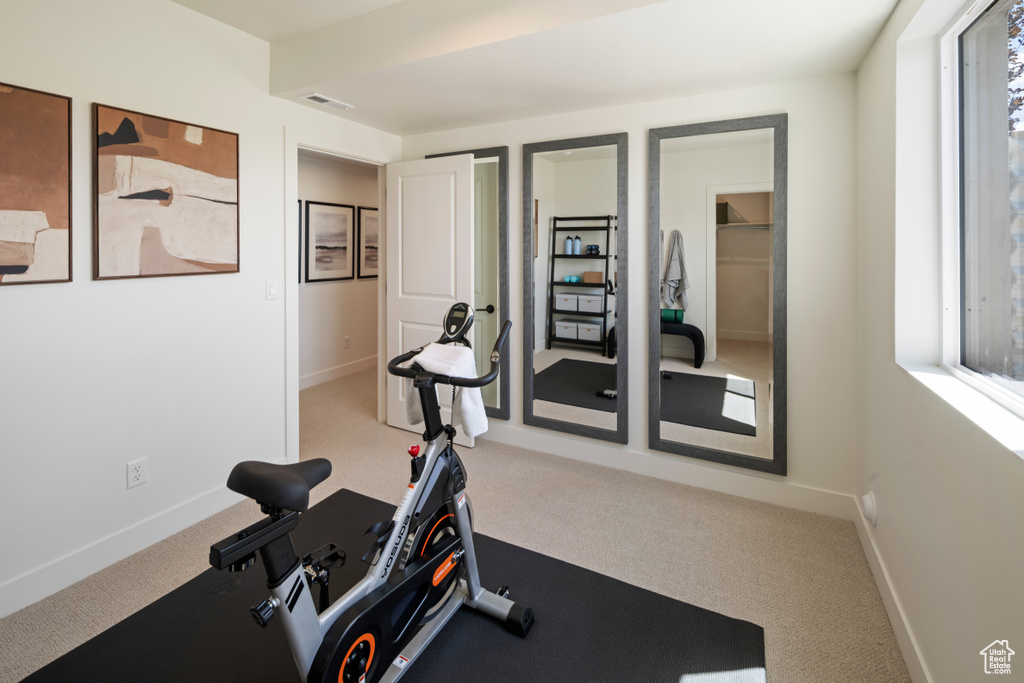 Exercise room featuring carpet and baseboards