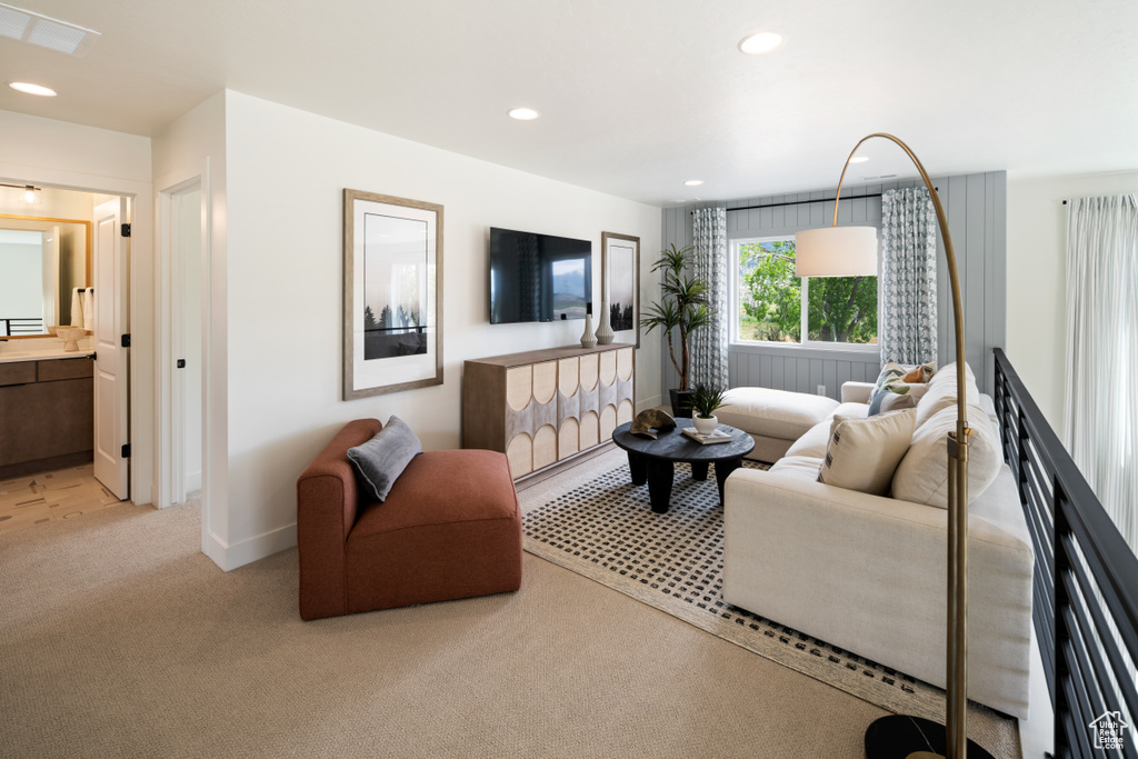 Living room with light carpet, recessed lighting, and baseboards