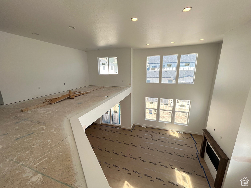 Unfurnished living room featuring plenty of natural light and recessed lighting