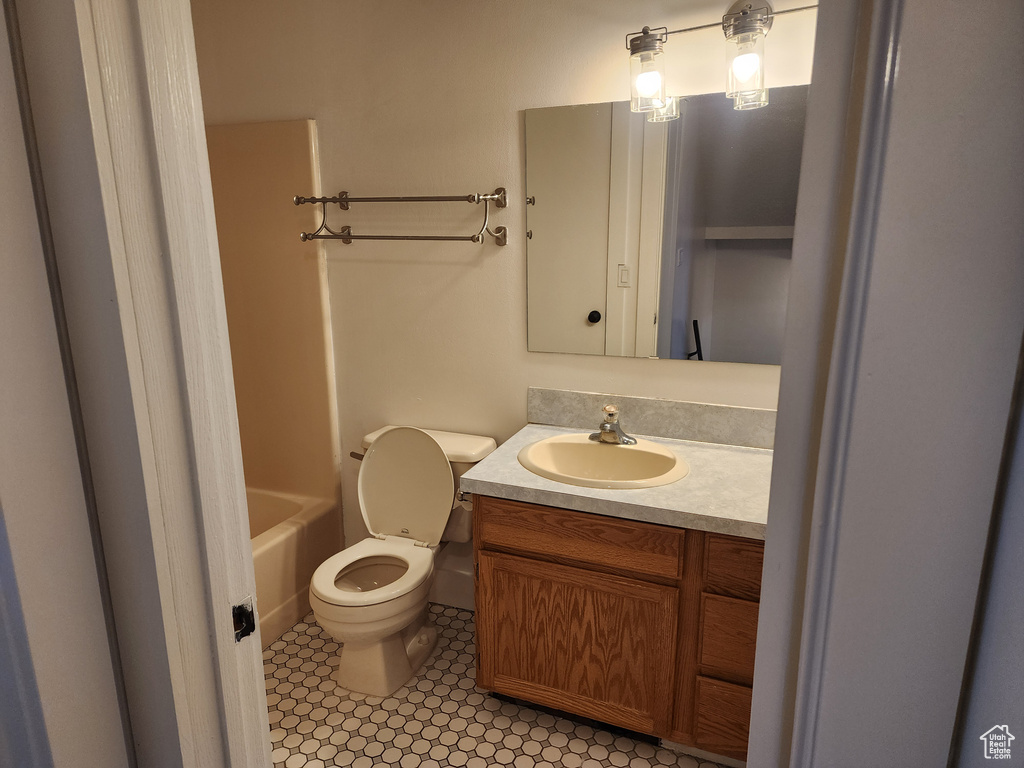Bathroom featuring toilet, vanity, and a bathtub