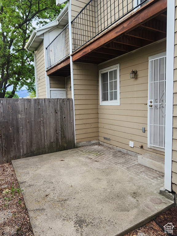 View of patio / terrace with a balcony and fence