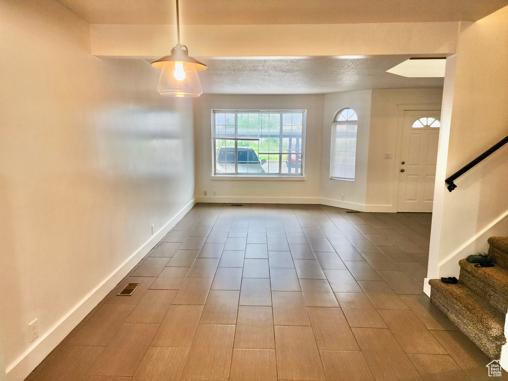 Foyer featuring stairway and baseboards