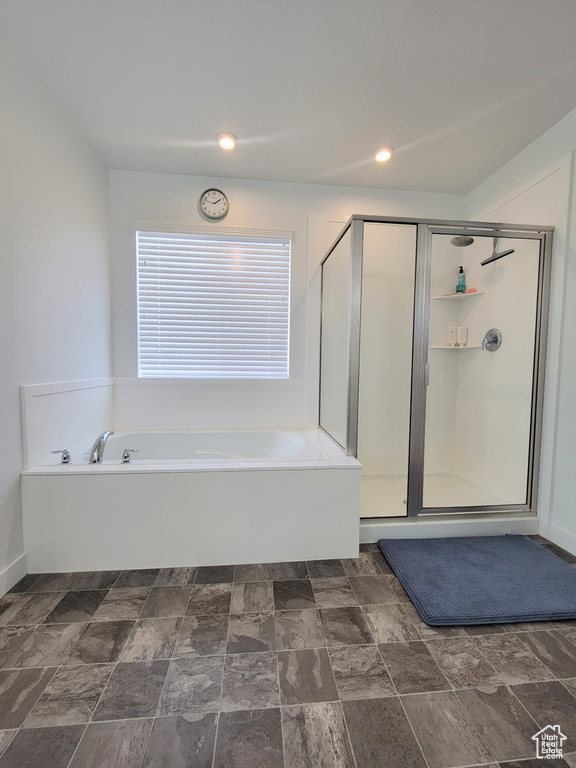 Full bath featuring a garden tub and a stall shower