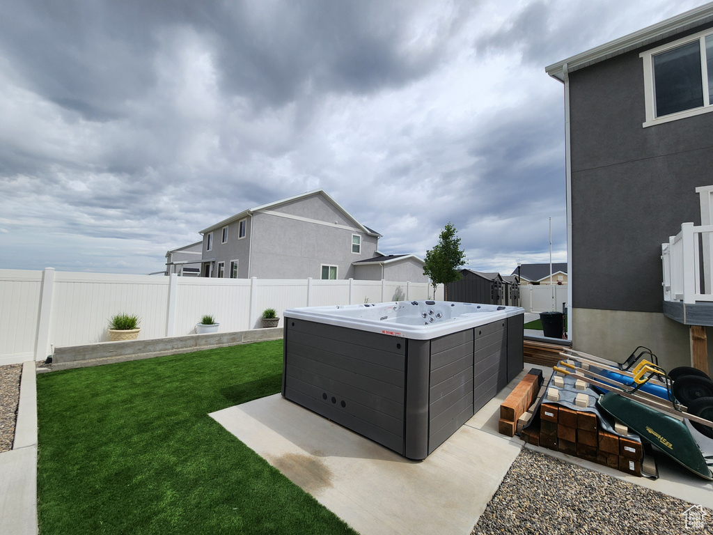 View of yard with a hot tub and a residential view