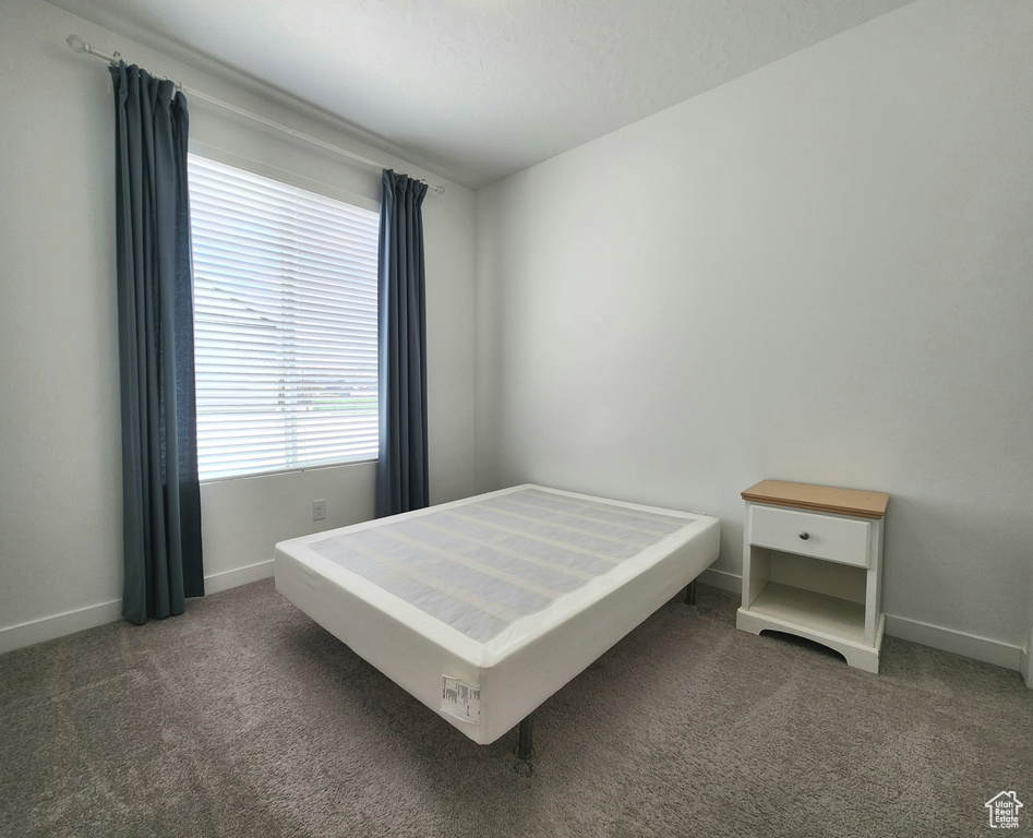Carpeted bedroom with baseboards