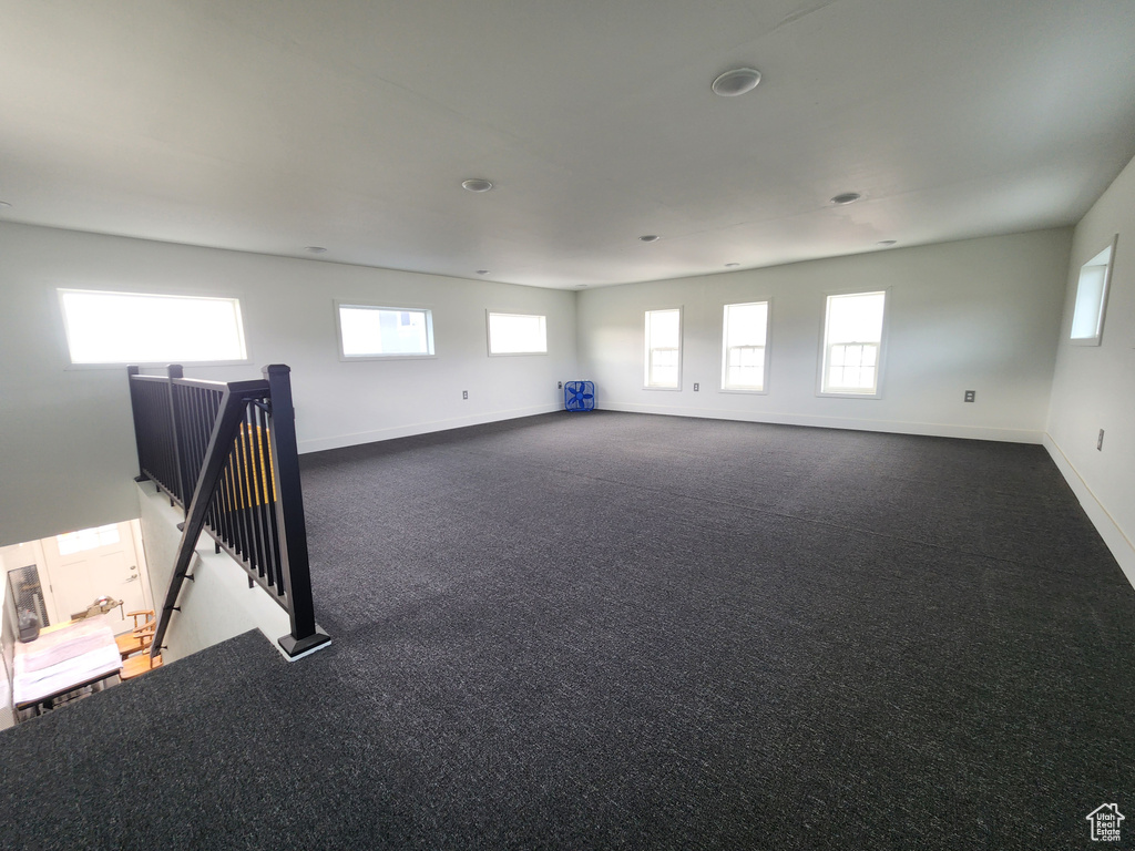 Unfurnished room featuring baseboards and carpet