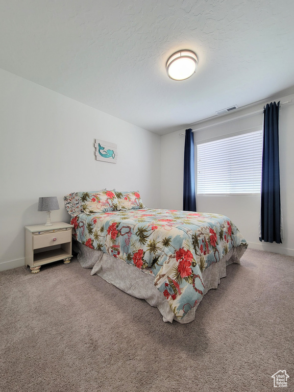 Carpeted bedroom featuring baseboards