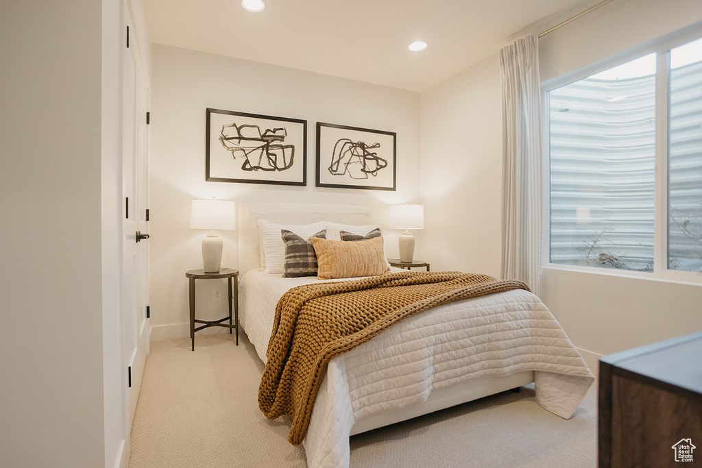 Bedroom with light colored carpet, recessed lighting, and baseboards