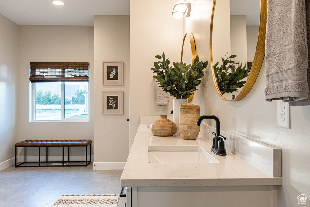Bathroom with double vanity, tile patterned floors, recessed lighting, and baseboards