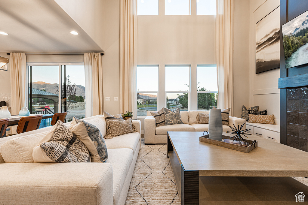 Living area with a high ceiling, recessed lighting, and a mountain view