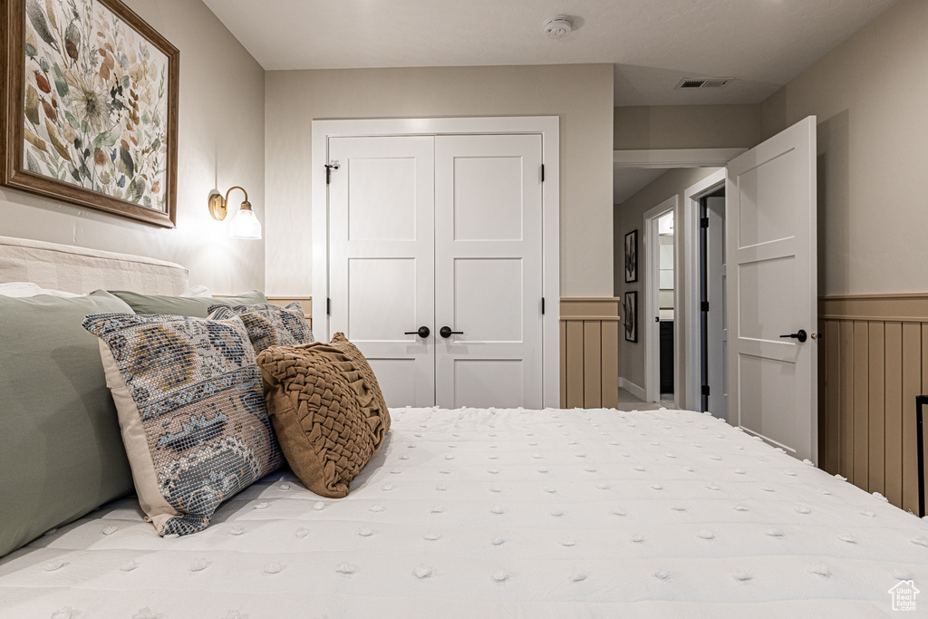 Bedroom with a closet and wainscoting
