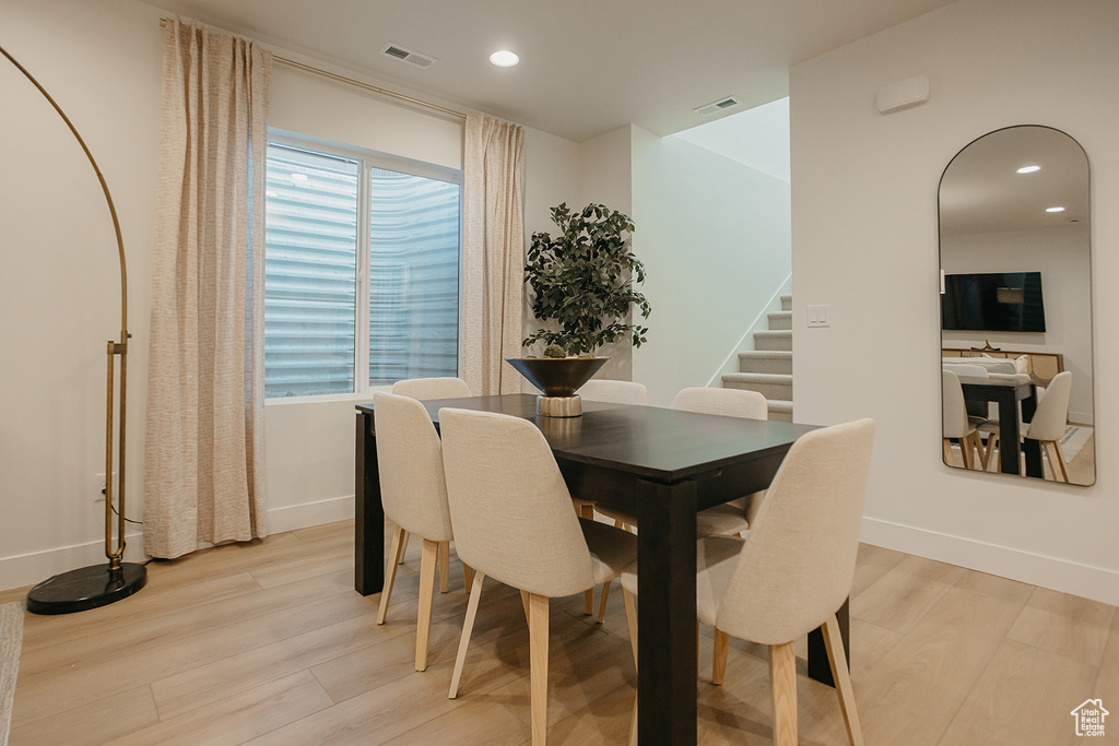 Dining room with light wood-style floors, stairway, recessed lighting, and baseboards