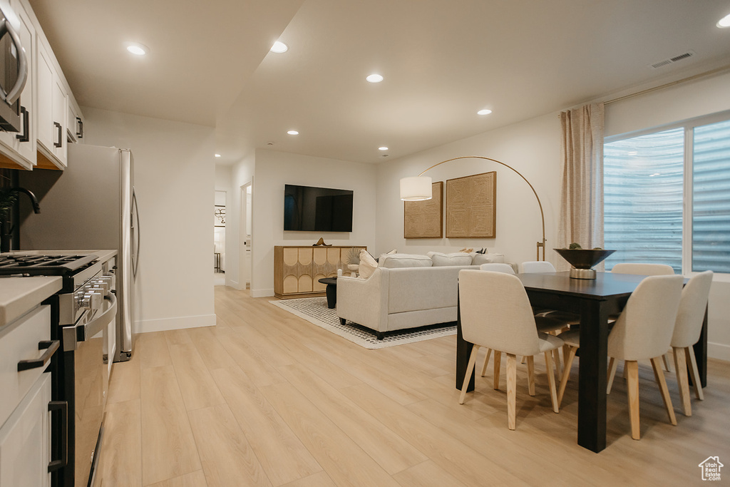 Dining area featuring light wood-style flooring, recessed lighting, and baseboards