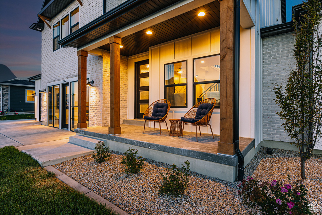 View of patio / terrace with a porch and a garage
