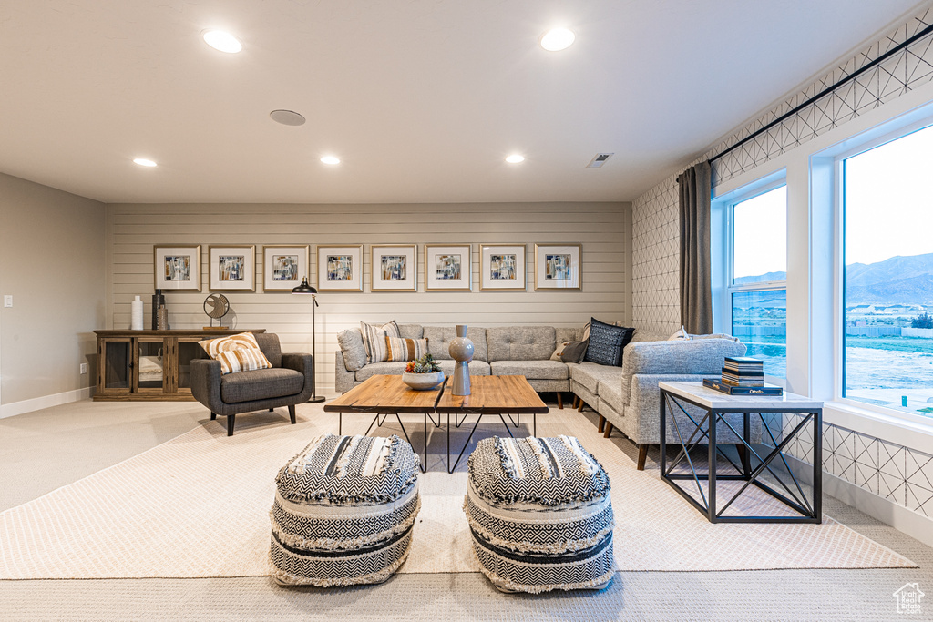 Carpeted living room featuring recessed lighting, plenty of natural light, and baseboards