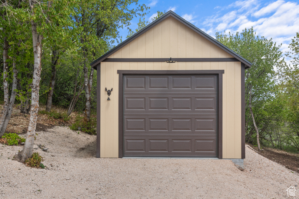 Detached garage with dirt driveway
