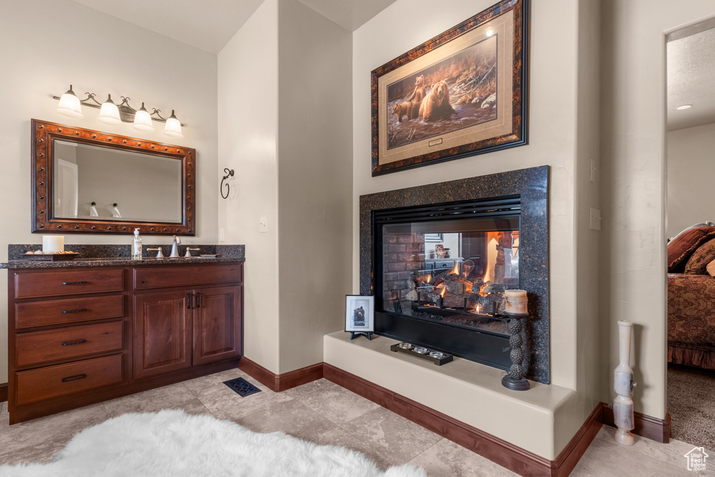 Ensuite bathroom featuring baseboards and vanity