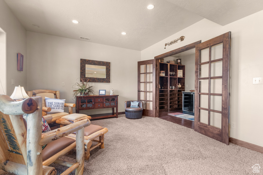 Sitting room with carpet flooring, recessed lighting, baseboards, and french doors