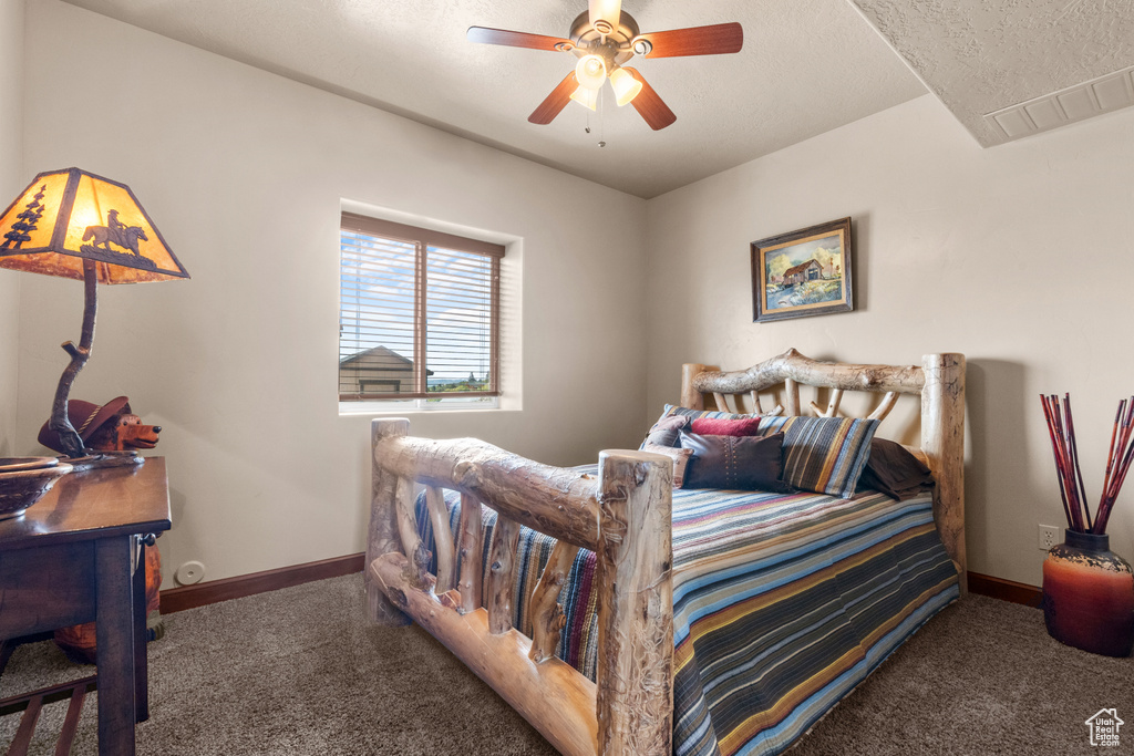 Carpeted bedroom with baseboards and a ceiling fan