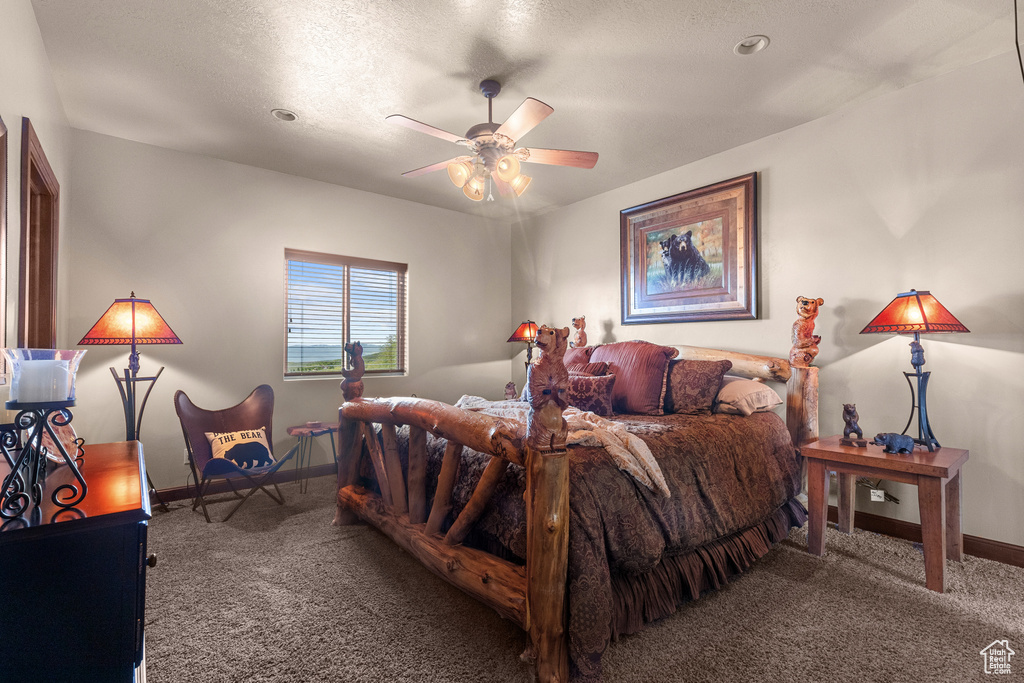 Carpeted bedroom with baseboards and a ceiling fan