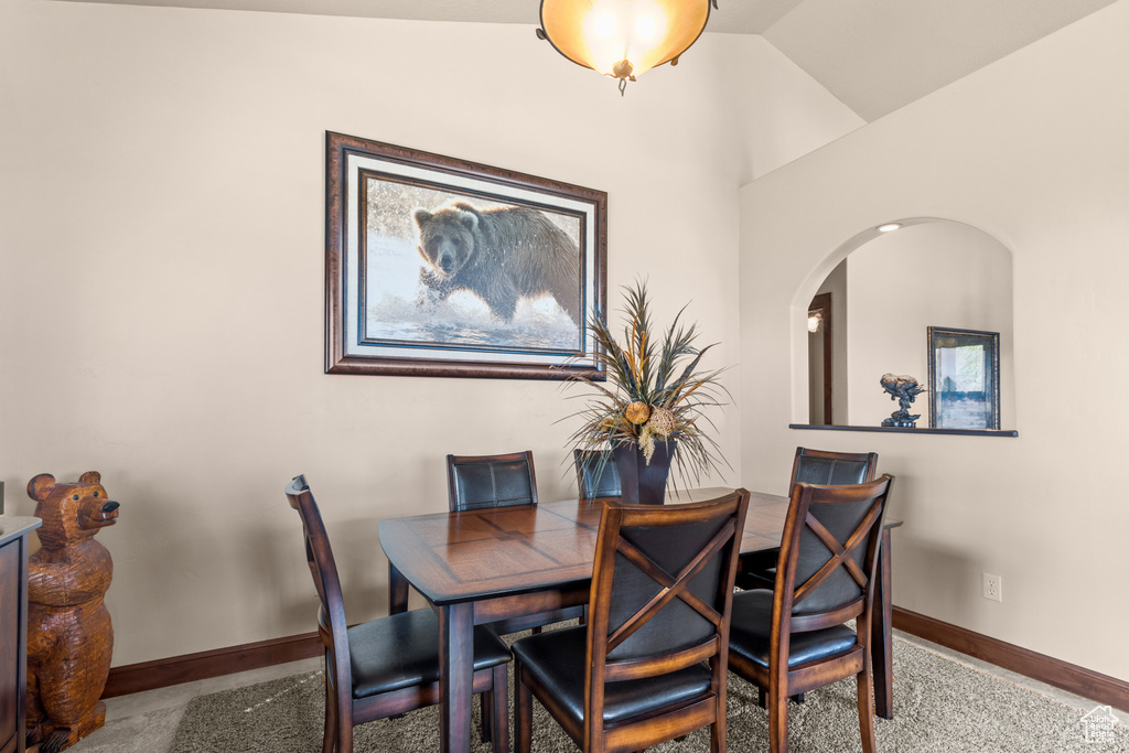 Dining area with baseboards and arched walkways