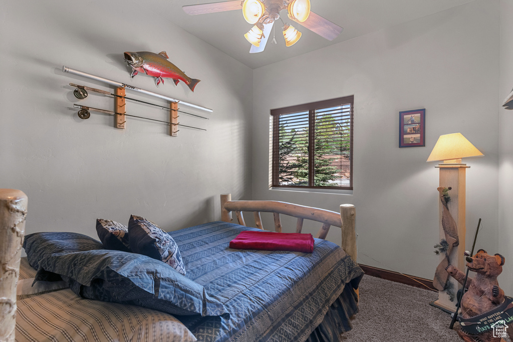 Bedroom with carpet, baseboards, and a ceiling fan