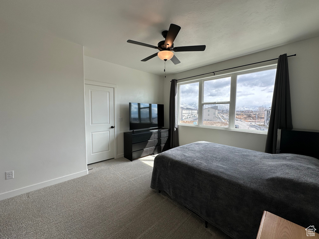 Bedroom with carpet, baseboards, and a ceiling fan
