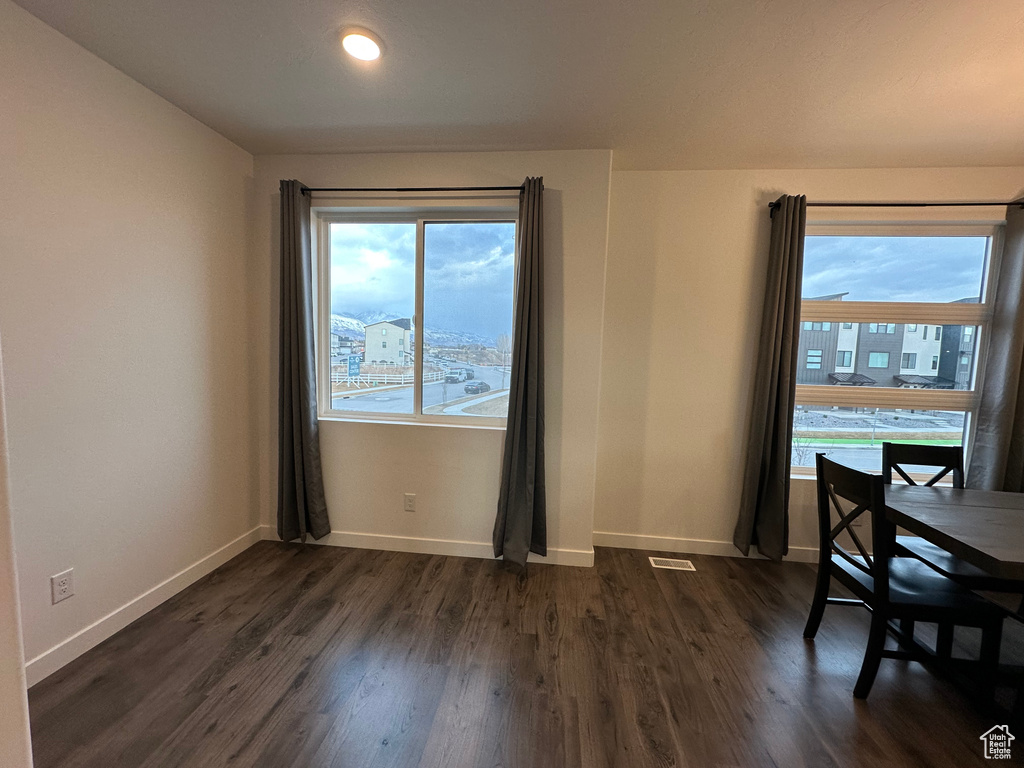 Dining room with baseboards and dark wood-style floors