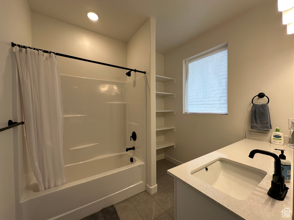 Bathroom featuring tile patterned floors, shower / tub combo with curtain, vanity, and recessed lighting
