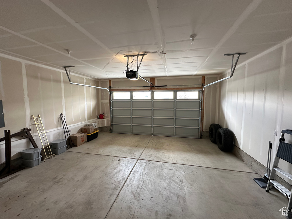 Garage featuring a garage door opener and electric panel