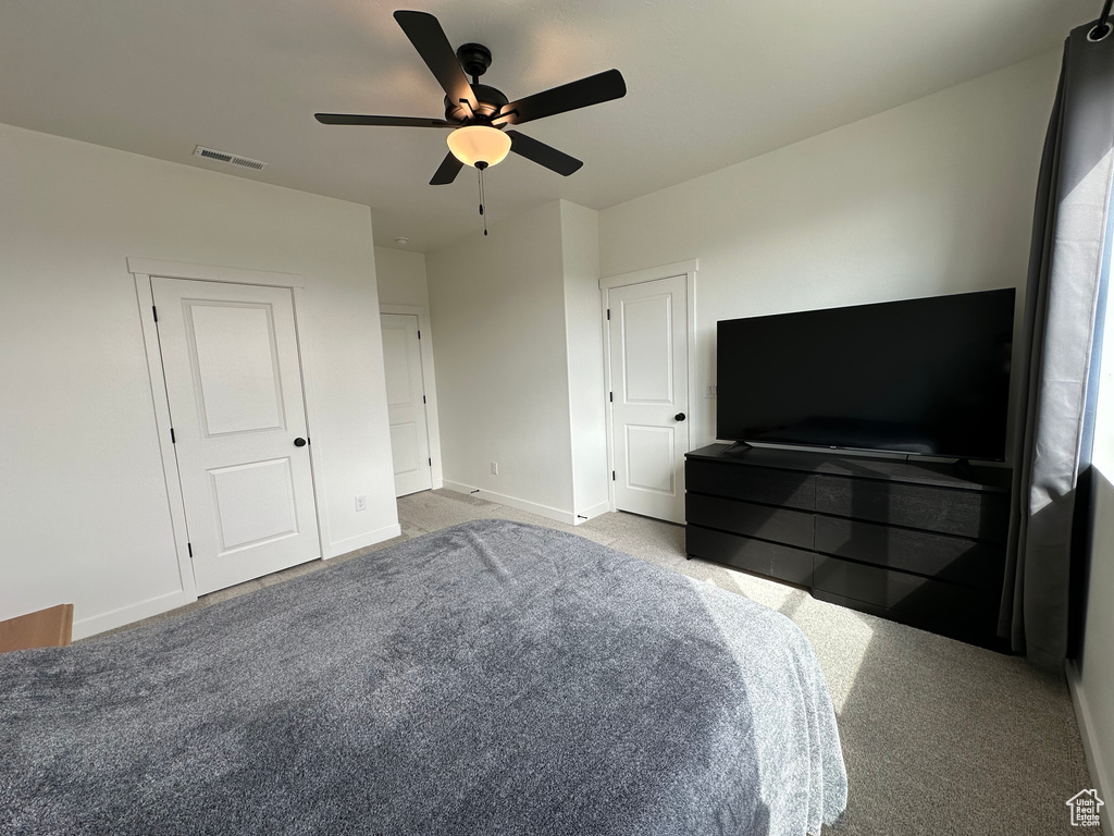 Unfurnished bedroom featuring carpet floors, baseboards, and ceiling fan