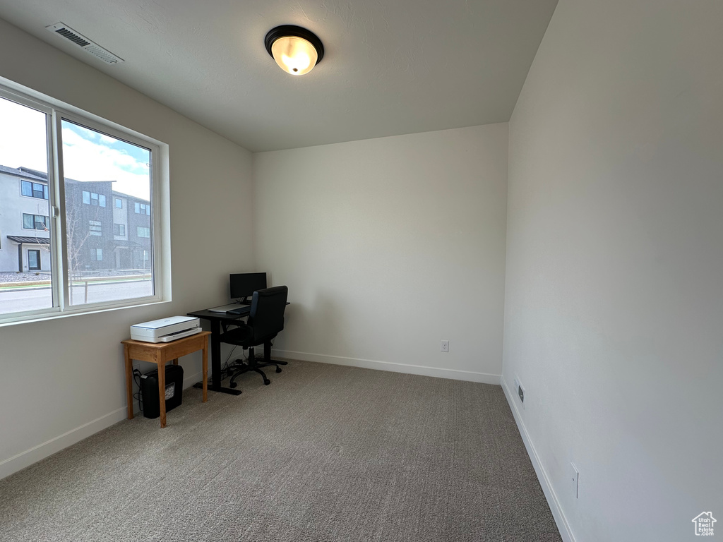 Carpeted office with baseboards