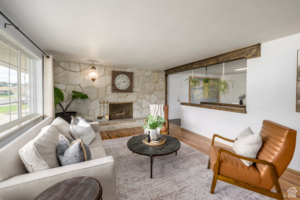 Living area featuring wood finished floors and a stone fireplace