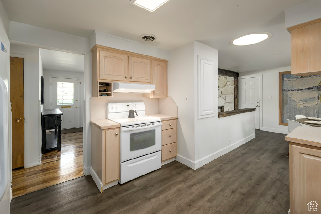 Kitchen featuring white electric range, light brown cabinets, under cabinet range hood, and dark wood-type flooring
