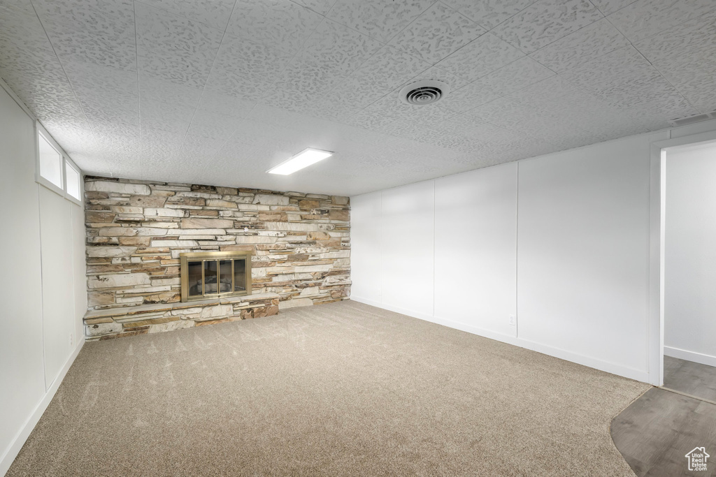 Below grade area featuring a fireplace and carpet floors
