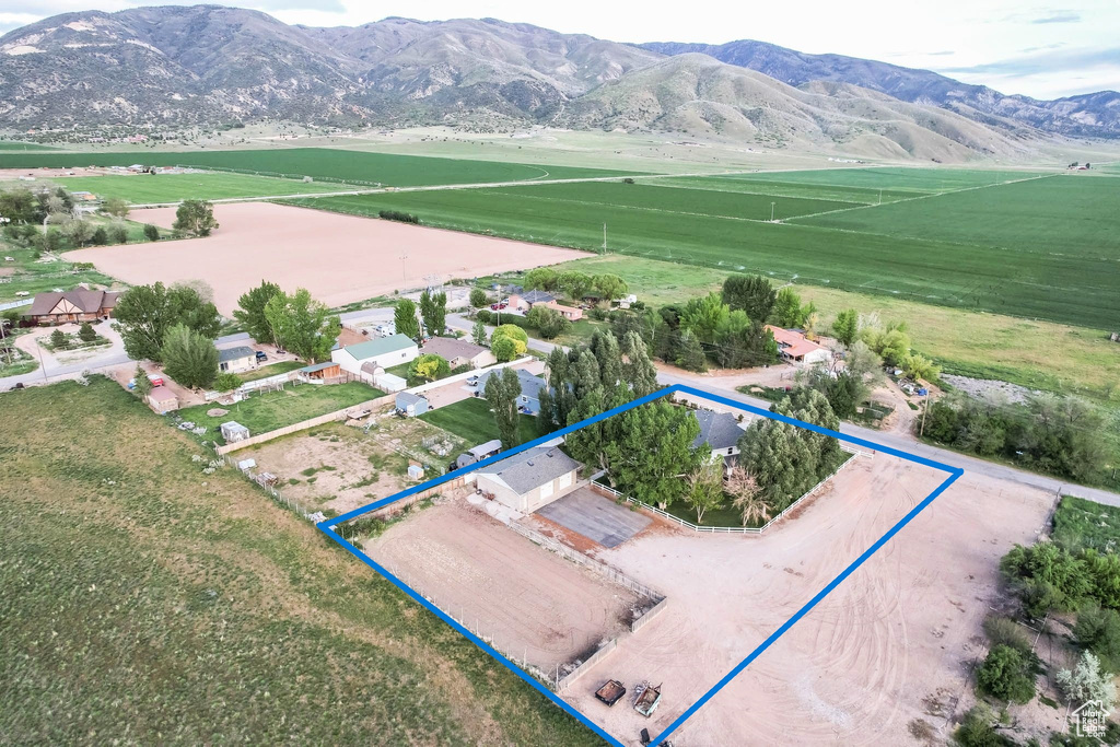 Overview of rural landscape featuring a mountainous background and property parcel outlined