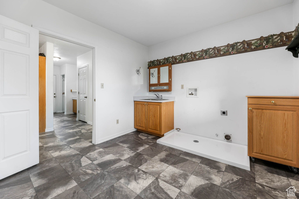 Laundry room featuring hookup for an electric dryer, hookup for a washing machine, hookup for a gas dryer, cabinet space, and baseboards