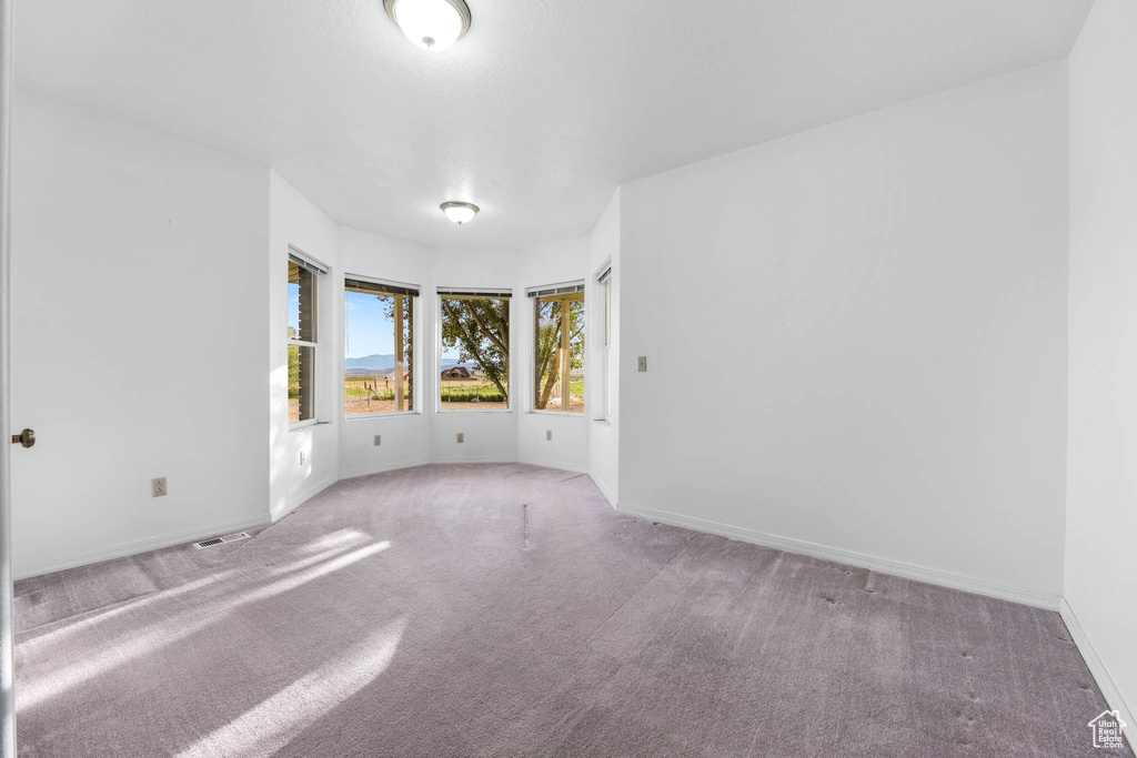 Unfurnished room featuring carpet flooring and baseboards