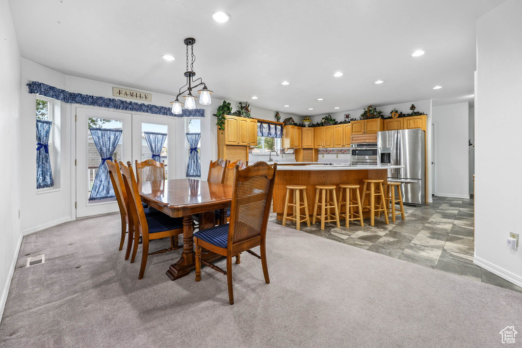 Dining space featuring recessed lighting, baseboards, french doors, and light carpet