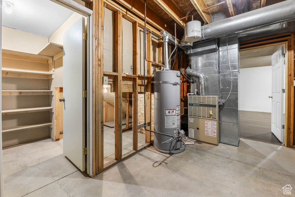 Utility room with water heater and heating unit