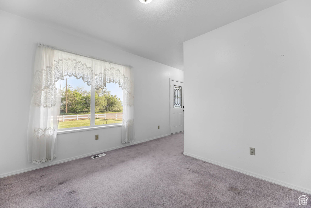Unfurnished room featuring carpet floors and baseboards