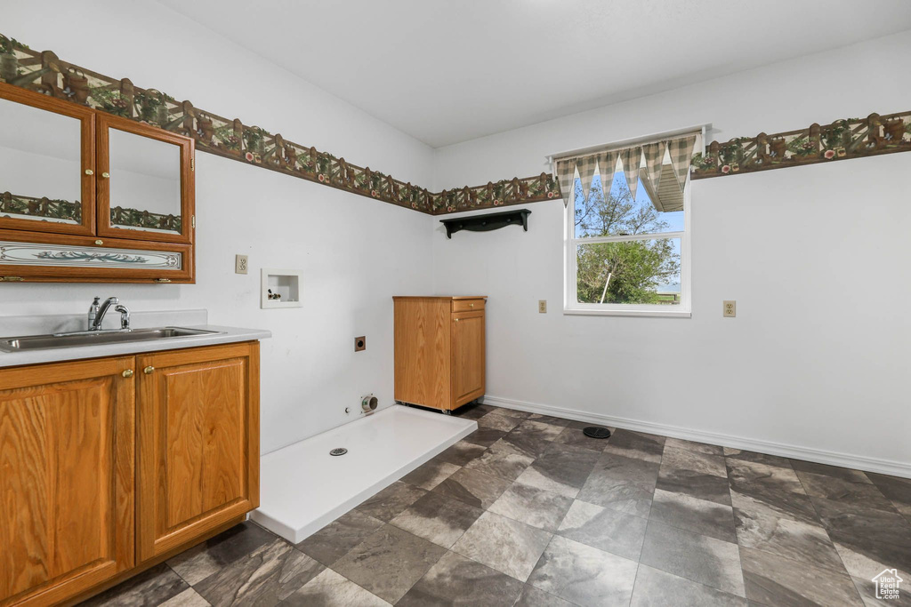 Bathroom with baseboards, vanity, and stone finish floors